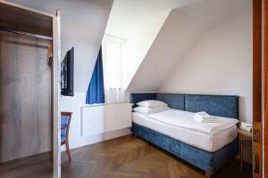 Posteľ alebo postele v izbe v ubytovaní Hotel Tanzberg Mikulov
