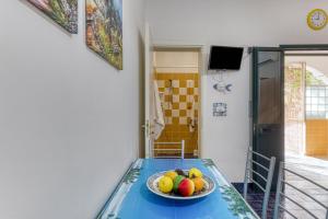 a bowl of fruit on a table in a room at studio Apartment mono Glicine with Private Garden in Torre Pali  +2 photos