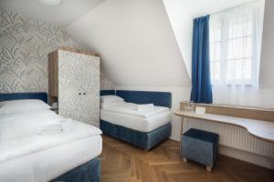 Posteľ alebo postele v izbe v ubytovaní Hotel Tanzberg Mikulov