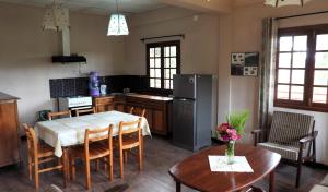 a kitchen with a table and chairs and a refrigerator at Lovasoa 4C in Antsirabe