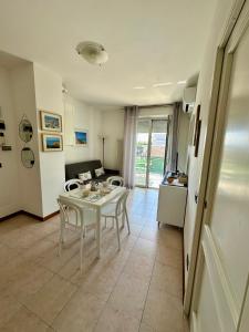 a kitchen and a living room with a table and chairs at Appartamento delle Vele in Bellaria-Igea Marina