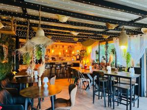 a restaurant with tables and chairs and a bar at La Villa Tosca in Callas