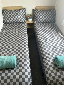 two beds sitting next to each other in a room at Highfield Grange Holiday Park in Clacton-on-Sea +6 photos