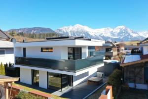 a house with a view of mountains at Alpin Chalet Arte in Söll