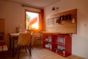 a kitchen and dining room with a table and a window at Panoramaapartment am Ochsenkopf in Bischofsgrün