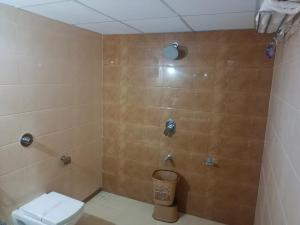a bathroom with a toilet and a shower at Flamingo Club and Resort Una 3 Km Away from Diu Check Post in Diu