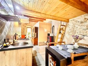 a kitchen with a sink and a counter top at Hostdomus - Fuggi nel Verde in Finale Ligure