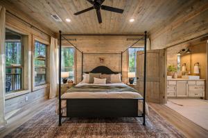 a bedroom with a bed and a ceiling fan at Pet friendly family cabin with firepit creek outdoor kitchen playset & more in Broken Bow