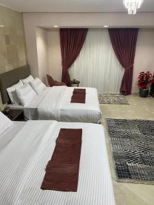 Voodi või voodid majutusasutuse Aziz Egypt Pyramids Hotel toas
