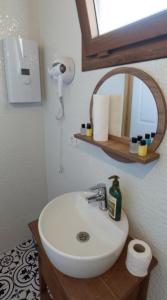 a bathroom with a white sink and a mirror at KAVURLUKOZ KaraburuN in Karaburun