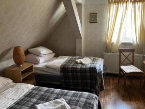 a hotel room with two beds and a window at Pensjonat U Kota Wasyla in Chodzież +29 photos