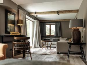 a living room with a couch and a table at Chalet Cecilia inklusive Spa- Area in Obergurgl