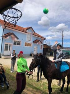 a woman playing with a girl on a horse with a ball at The Countryside Retreat in Rankovce