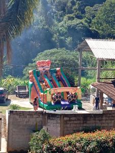 a large inflatable water slide in a park at Sítio Araújo in Ibiúna