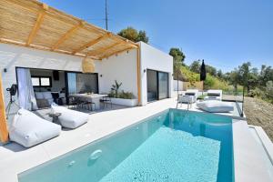 a villa with a swimming pool and a house at Etherial View Villas Skiathos in Skiathos