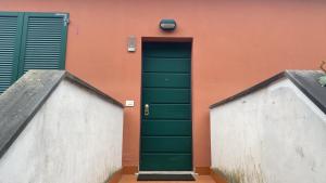 a green door of a building with a orange wall at Oasi Verde 1 in Lerici