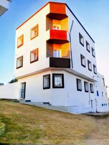 a building with colorful windows on the side of it at Résidence Maya in El Haouaria