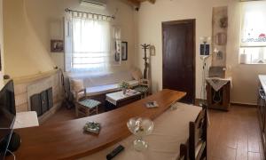 a living room with a table and a couch at Elsa Apartment in Aegina Town