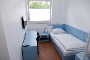 a small room with a bed and a window at Stern Hotel Hannover in Hannover