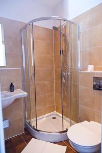 a bathroom with a shower with a toilet and a sink at Stern Hotel Hannover in Hannover