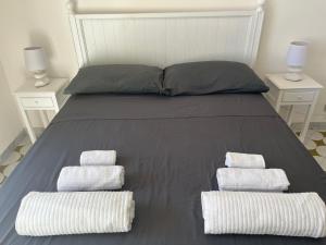 A bed or beds in a room at Villa Bianca, Seaside panoramic Rooftop