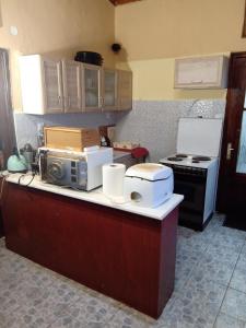 a kitchen with a counter with a microwave and a stove at mountain and sea in kallithea Halkidiki in Kallithea Halkidikis