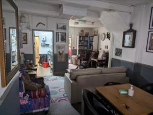 a living room with a couch and a table at The Fox in Bristol