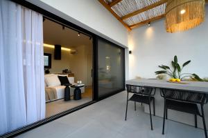 a room with a bed and a table and chairs at Etherial View Villas Skiathos in Skiathos