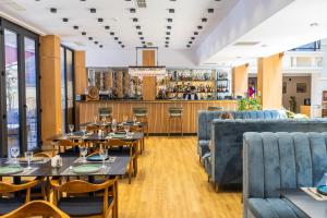 a restaurant with tables and chairs and a bar at Mukhrantubani Boutique Hotel in Tbilisi City