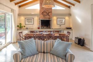 a living room with a couch and a table at Delightfully Casual & Spacious in Cape St Francis