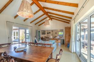 a dining room with a table and chairs at Delightfully Casual & Spacious in Cape St Francis