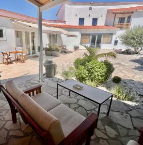a patio with a couch and a table at The Courtyard Episkopi Guest Houses in Episkopi Limassol