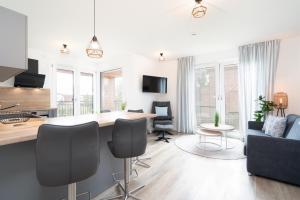 a kitchen and living room with a table and chairs at Steife Brise Nr 2 in Neustadt in Holstein