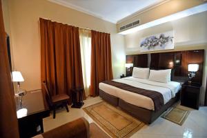 Postel nebo postele na pokoji v ubytování Emirates Stars Hotel Apartments Sharjah + 37 fotografií