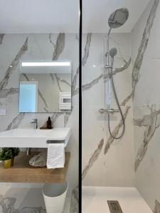 a bathroom with a shower and a sink at CADIAMARE in Zonza