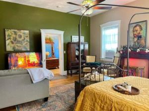 a bedroom with a bed and a ceiling fan at The Mediterranean House - Beautiful Downtown House in Perryville