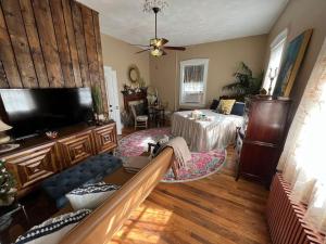 a living room with a couch and a tv at The Mediterranean House - Beautiful Downtown House in Perryville