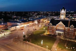 a view of a town at night with a clock tower at The Mediterranean House - Beautiful Downtown House in Perryville