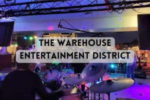 a man playing drums at a concert with a sign that reads the warrior instrument district at The Mediterranean House - Beautiful Downtown House in Perryville
