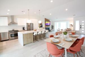 a kitchen and living room with a table and chairs at Summer fun in Indian Wells. Private Pool, 4BD, 3BA. in Indian Wells
