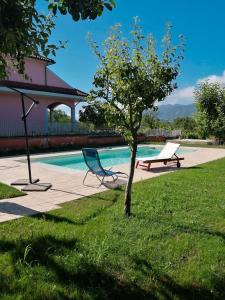 a chair and a bench next to a swimming pool at Casa Fiorella - Irpinia in Lioni