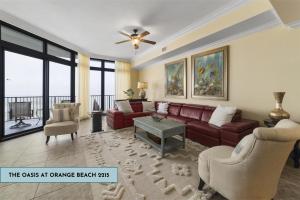 a living room with a couch and a table at The Oasis At Orange Beach 2215 by Liquid Life in Orange Beach
