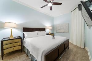 a bedroom with a bed and a ceiling fan at The Oasis At Orange Beach 2215 by Liquid Life in Orange Beach