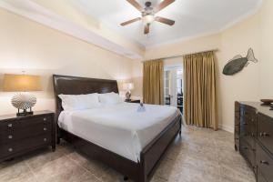 a bedroom with a bed and a ceiling fan at The Oasis At Orange Beach 2215 by Liquid Life in Orange Beach