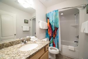 a bathroom with a sink and a shower and a toilet at The Oasis At Orange Beach 2215 by Liquid Life in Orange Beach