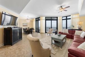 a living room with a couch and a table at The Oasis At Orange Beach 2215 by Liquid Life in Orange Beach