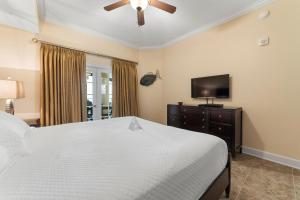 a bedroom with a bed and a flat screen tv at The Oasis At Orange Beach 2215 by Liquid Life in Orange Beach