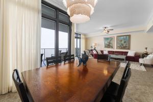 a dining room with a table and a couch at The Oasis At Orange Beach 2215 by Liquid Life in Orange Beach