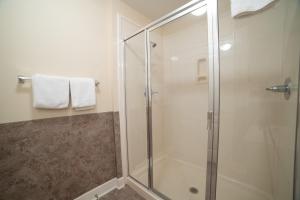 a shower with a glass shower stall in a bathroom at The Oasis At Orange Beach 2215 by Liquid Life in Orange Beach