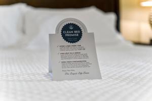 a small white tag on a white bed at The Oasis At Orange Beach 2215 by Liquid Life in Orange Beach